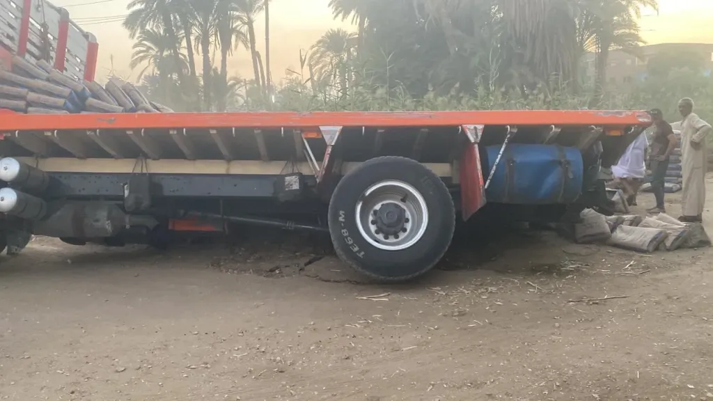 بسبب هبوط أرضي.. انقلاب تريلا محملة أسمنت وإصابة قائدها أعلى كوبري في قنا
